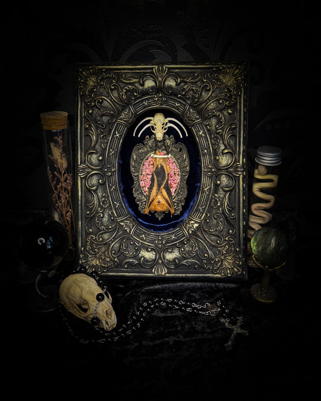 Floral Delight | Bats — handmade gothic wall decor with real preserved bat, bat skull, bone ribs, deep pink preserved flowers on navy velvet in aged hand-cast ornamental frame with glass, 25x19cm