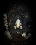 The Last Sacrament gothic frame with a mink skull, “blood” vial, two bird vertebrae and three inverted crosses on black velvet.