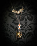 Handmade gothic necklace — mouse skull and jaw with dried flowers in hexagonal resin pendant, vertebrae connector, metal bat charm, carnelian beads