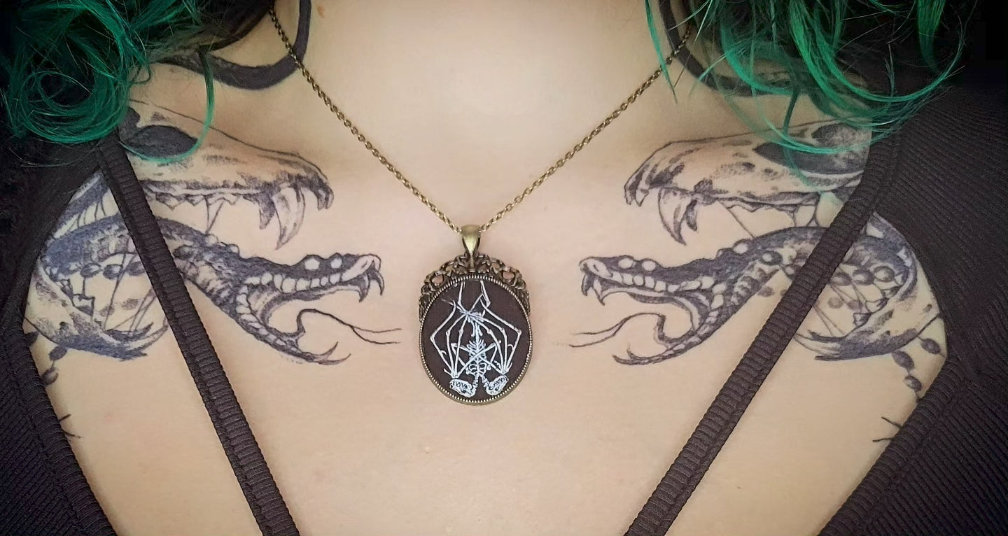 Handmade gothic necklace — hand-painted bat sigil, oval pendant with metal frame and chain, varnish finish