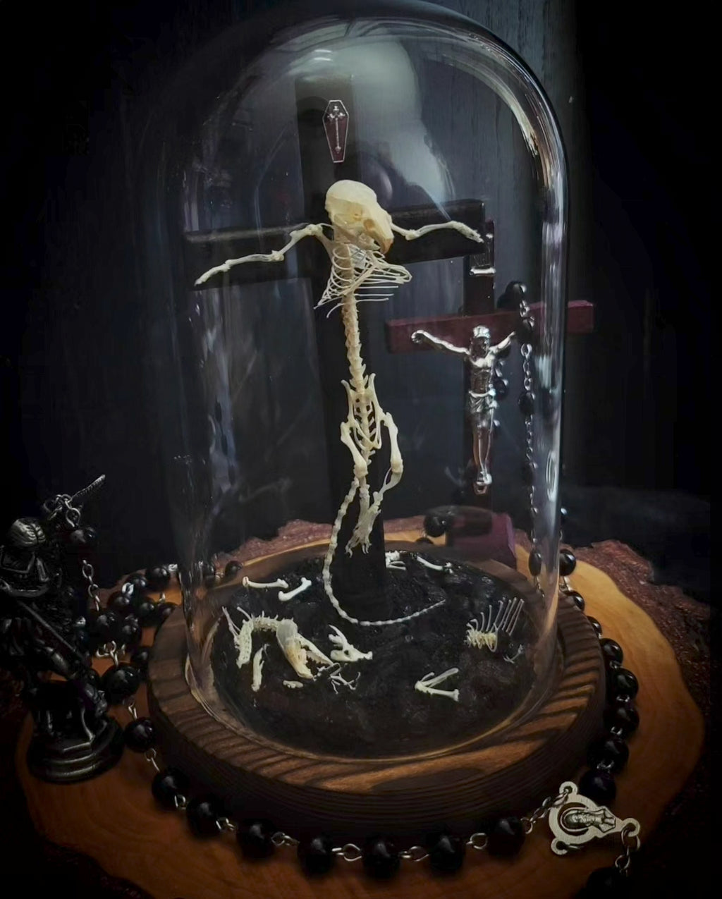 Crucifixa — handmade gothic glass dome display, made to order. Real mouse skeleton mounted on a cross under glass cloche on wooden base with occult elements, decorative bones and skeletal details. Dark ritual shrine decor.