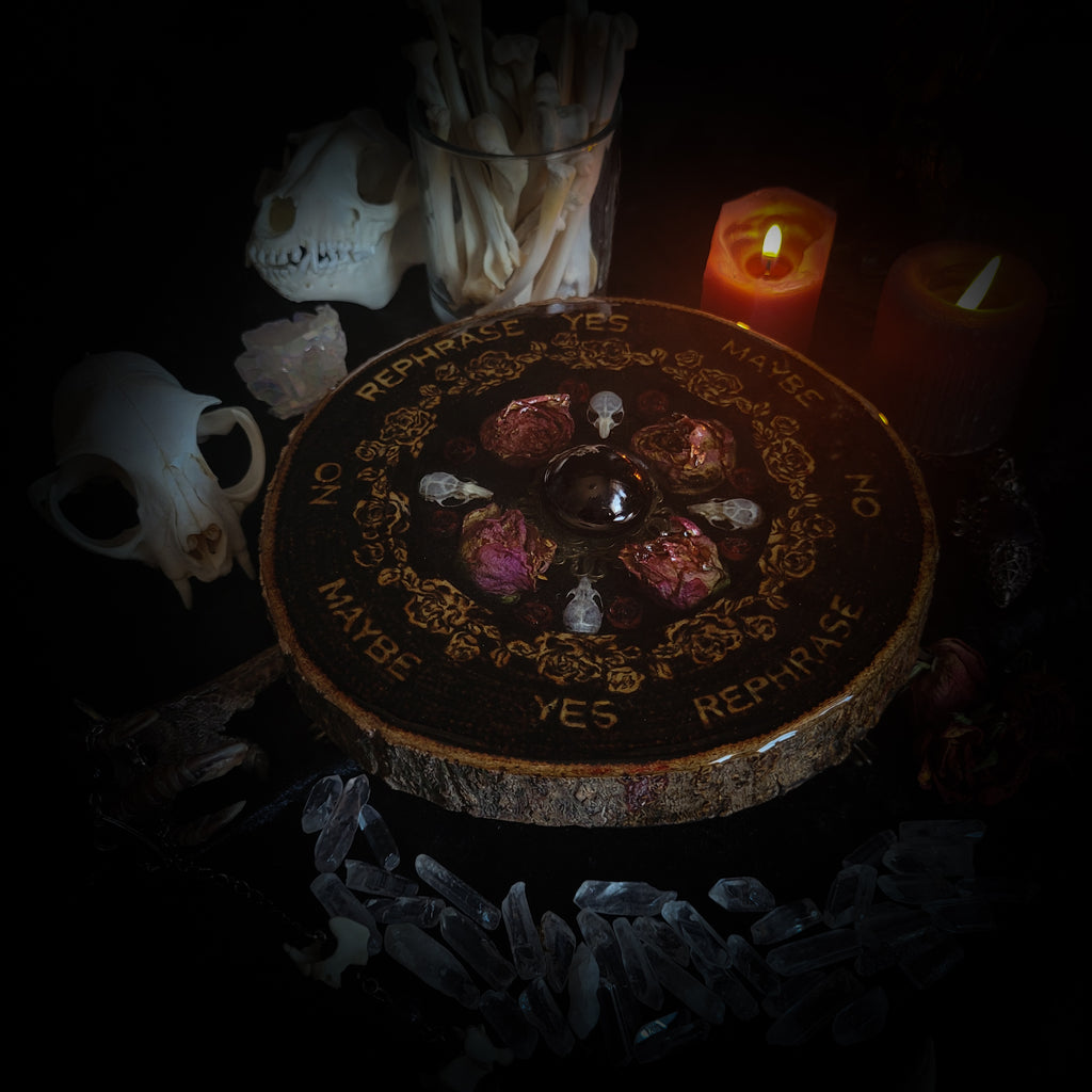 Wooden Pendulum Board — handmade divination pendulum board, made to order. Natural wood slice with hand-burned pyrography design, resin roses, crystals and ornamented legs. Custom witchcraft tool and altar decor by Morbid Oddities.