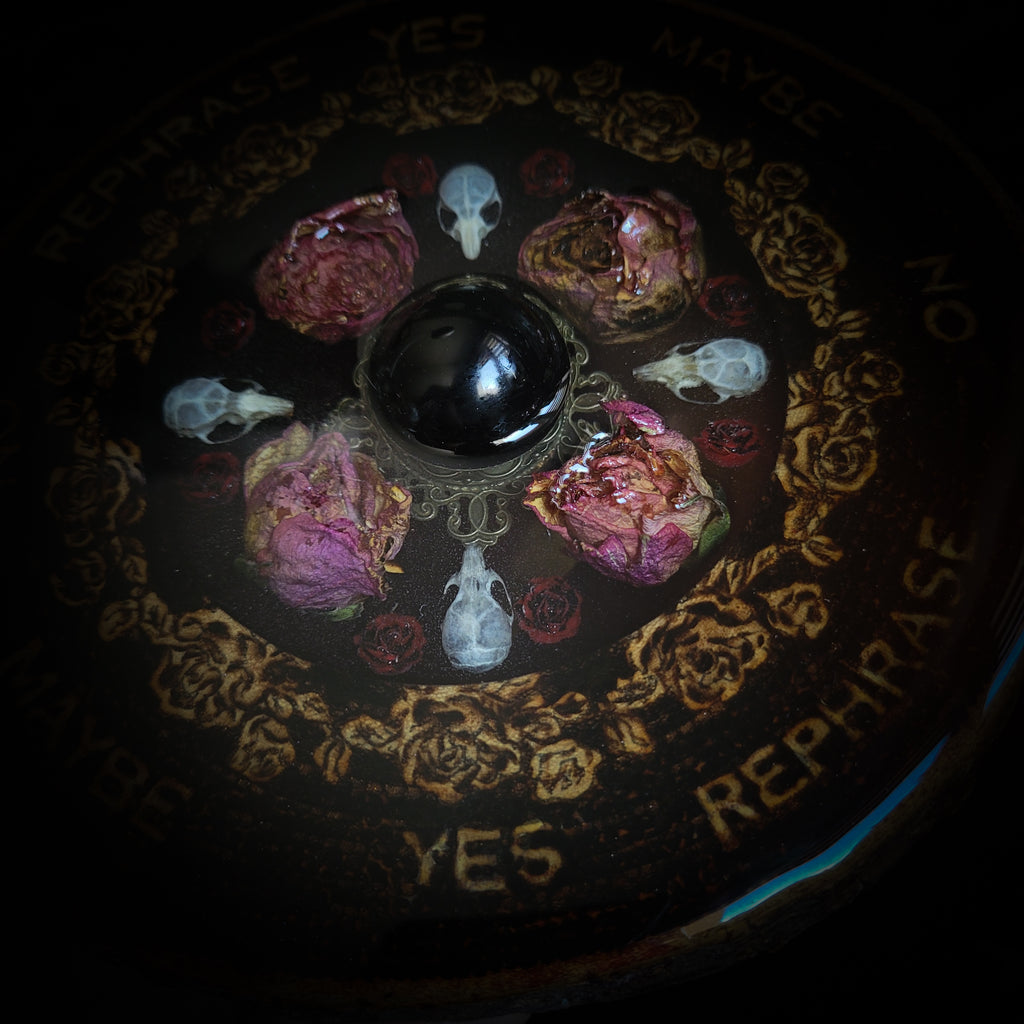 Wooden Pendulum Board — handmade divination pendulum board, made to order. Natural wood slice with hand-burned pyrography design, resin roses, crystals and ornamented legs. Custom witchcraft tool and altar decor by Morbid Oddities.