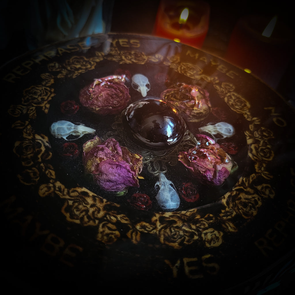 Wooden Pendulum Board — handmade divination pendulum board, made to order. Natural wood slice with hand-burned pyrography design, resin roses, crystals and ornamented legs. Custom witchcraft tool and altar decor by Morbid Oddities.