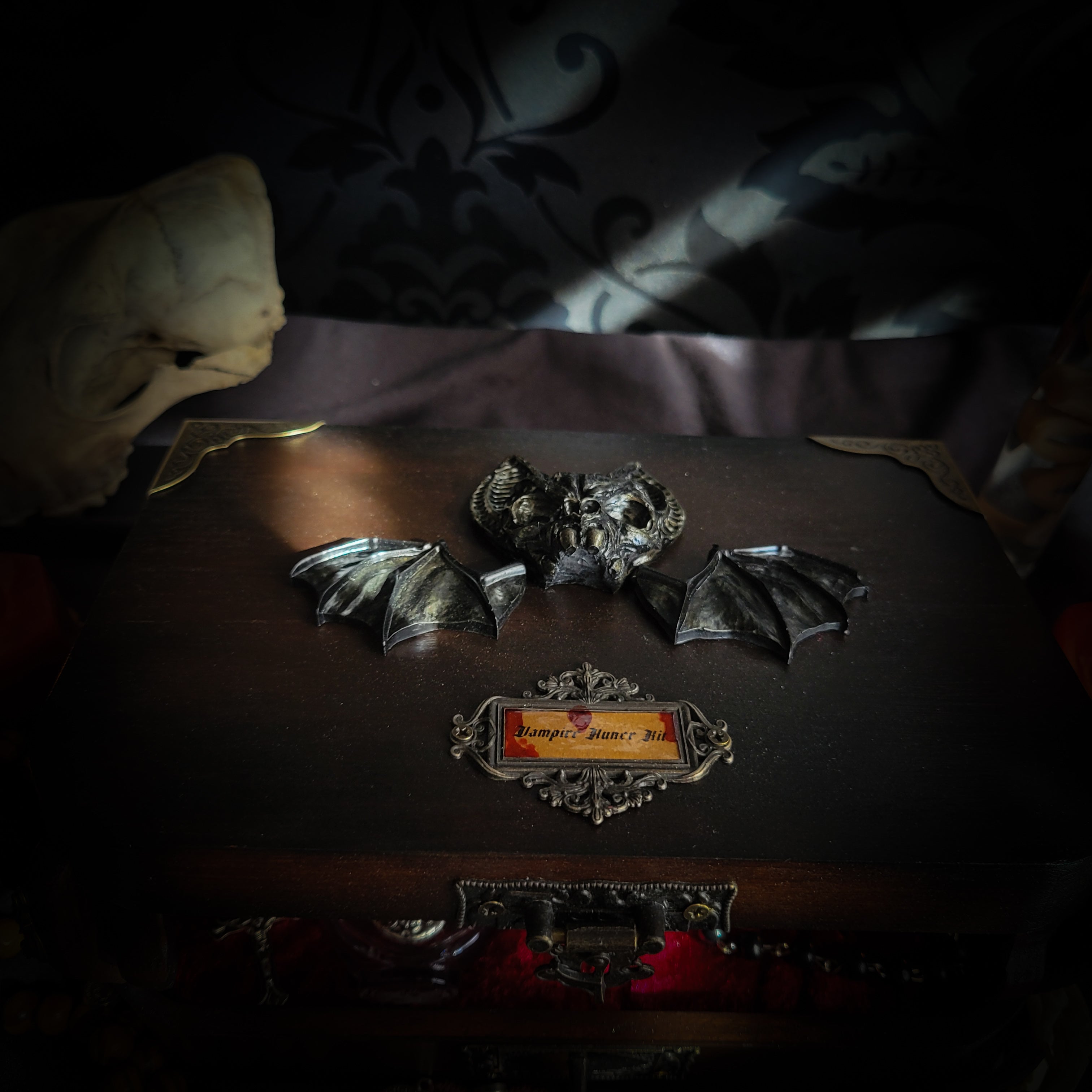 Vampire Hunter Kit — handmade gothic relic box, made to order. Hand-painted ornamented wooden suitcase with vampire stake, hammer, holy water, rosaries, crucifix, glass vials, miniature Bible and crimson velvet lining. Dark collectible decor, 23x17x9.5cm.