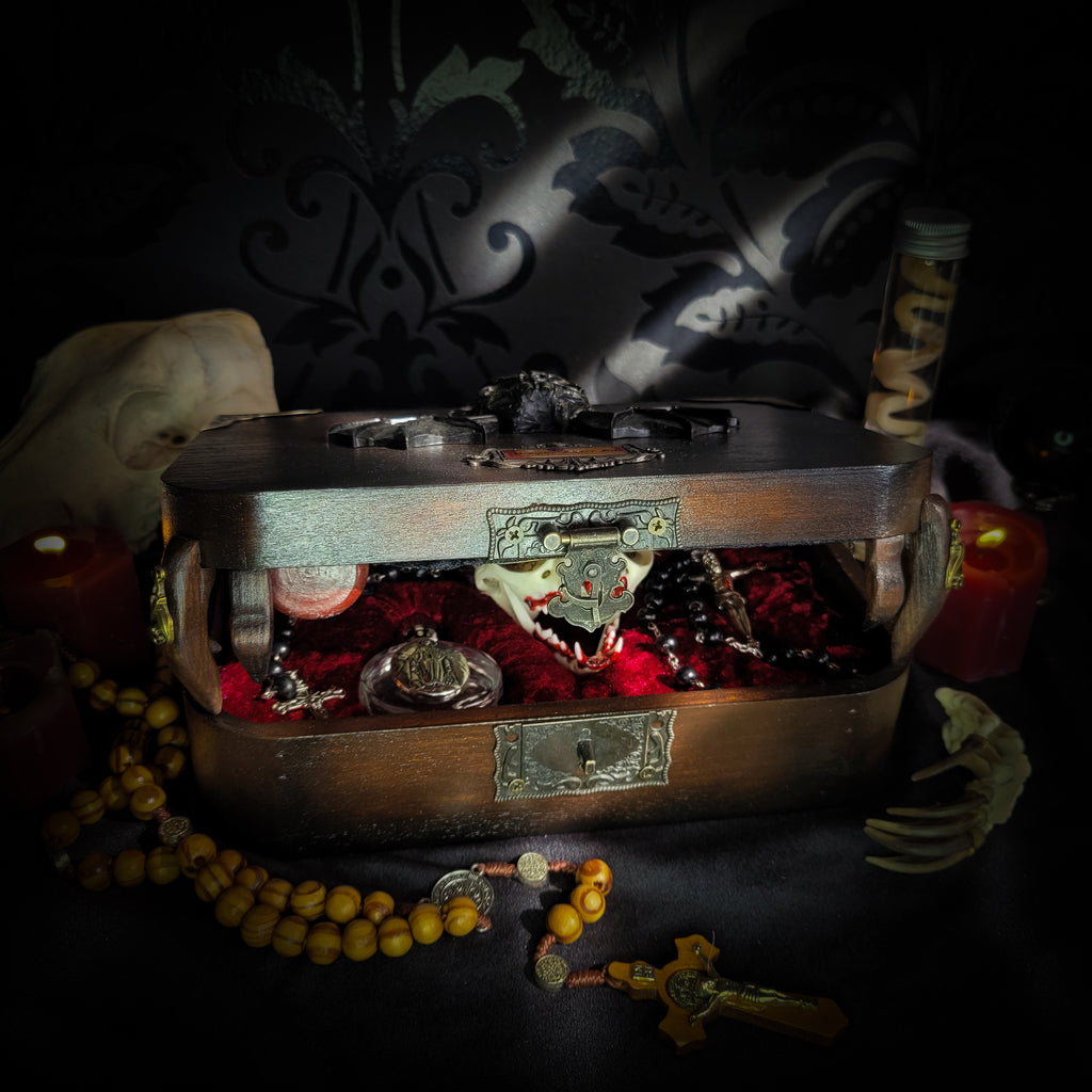 Vampire Hunter Kit — handmade gothic relic box, made to order. Hand-painted ornamented wooden suitcase with vampire stake, hammer, holy water, rosaries, crucifix, glass vials, miniature Bible and crimson velvet lining. Dark collectible decor, 23x17x9.5cm.