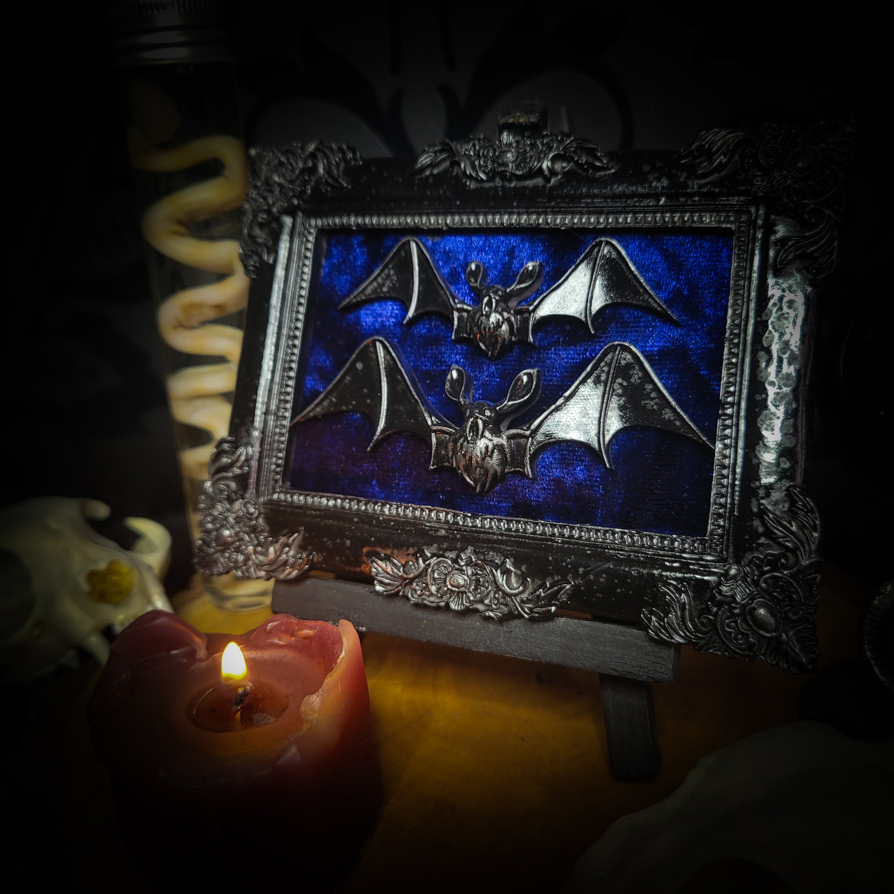 Nox Caelestis — handmade gothic shadowbox, made to order. Detailed handcrafted bat set in ornate decorative frame on deep blue velvet background. Nocturnal gothic wall decor, 12x9.5cm.