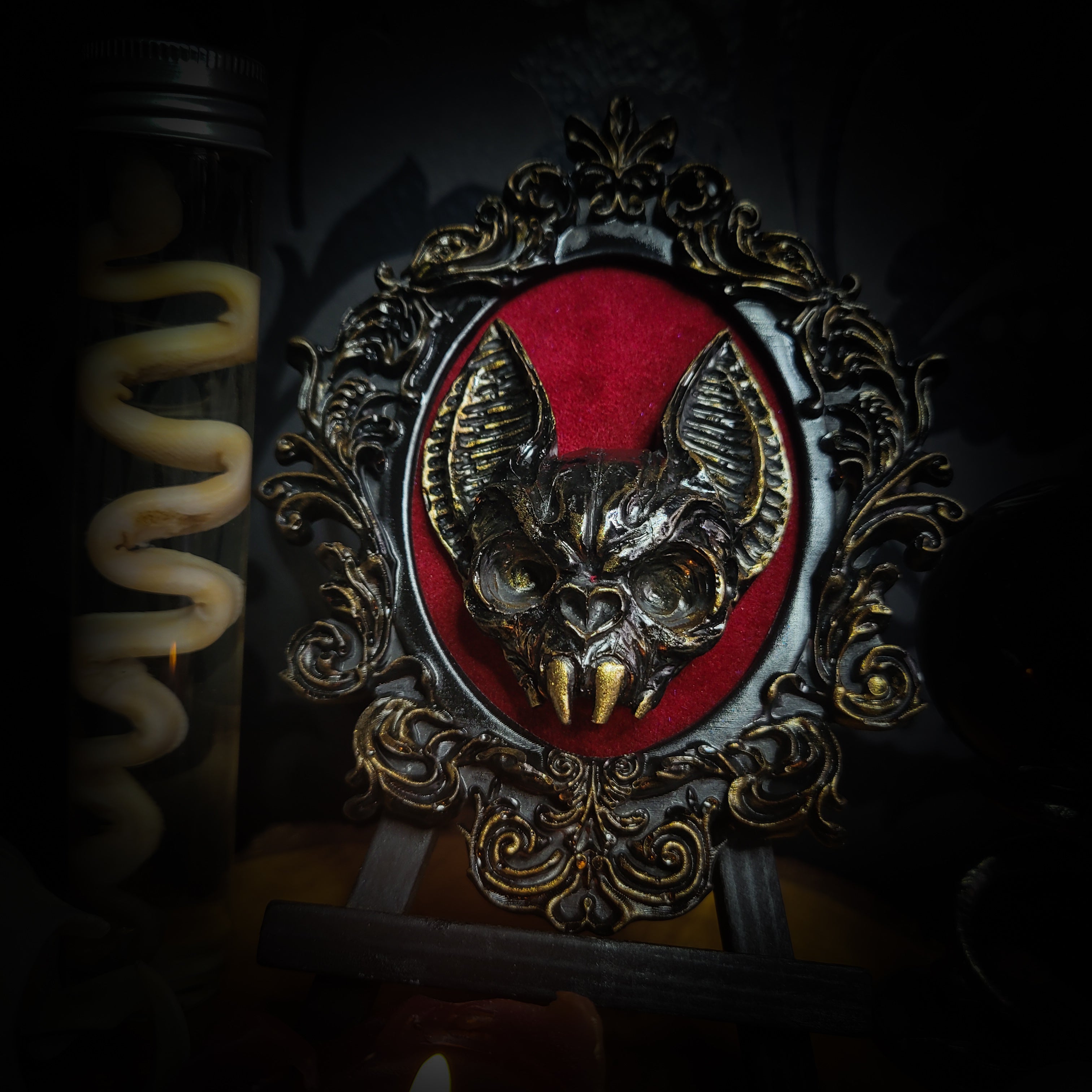 Handmade gothic wall frame featuring a detailed bat centerpiece set on deep blood-red velvet, enclosed in an ornate baroque-style frame. Dramatic, ritual-inspired made-to-order piece with rich crimson velvet and dark gothic aesthetic, 12.5x10cm | Morbid Oddities