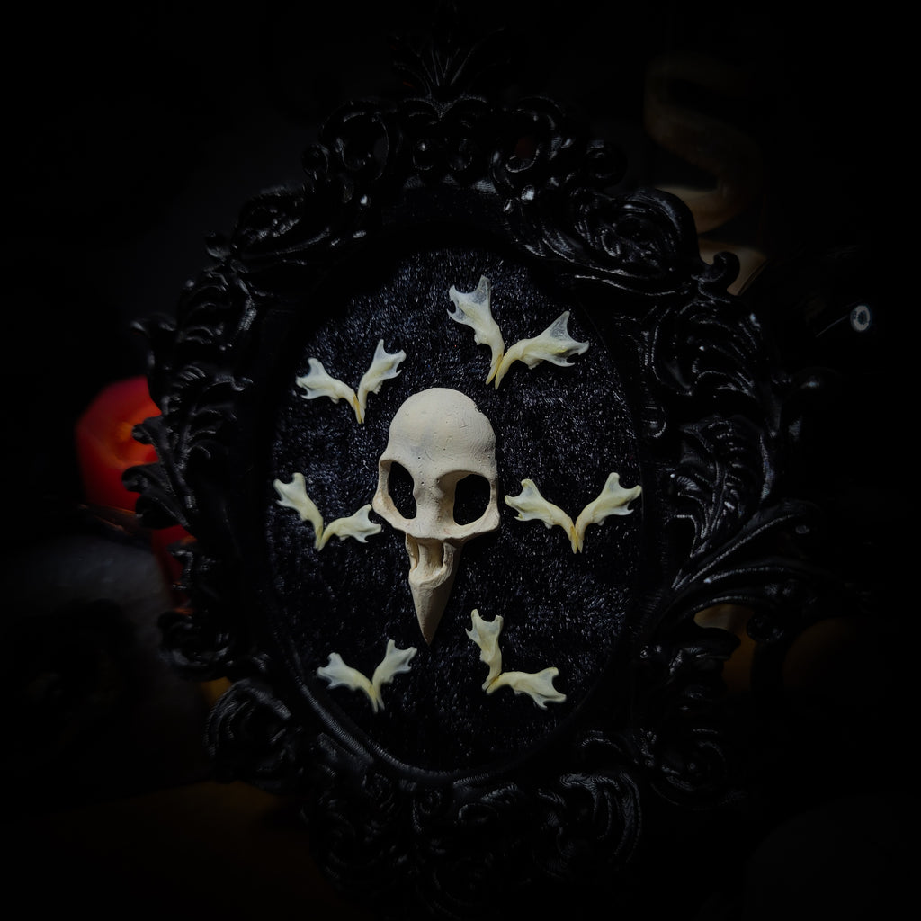 Halloween | Small Relics — handmade gothic wall frame with hand-cast crow skull, mouse jaws arranged in bat formation on black velvet textured background in hand-painted gothic frame, 12.5x10.5cm