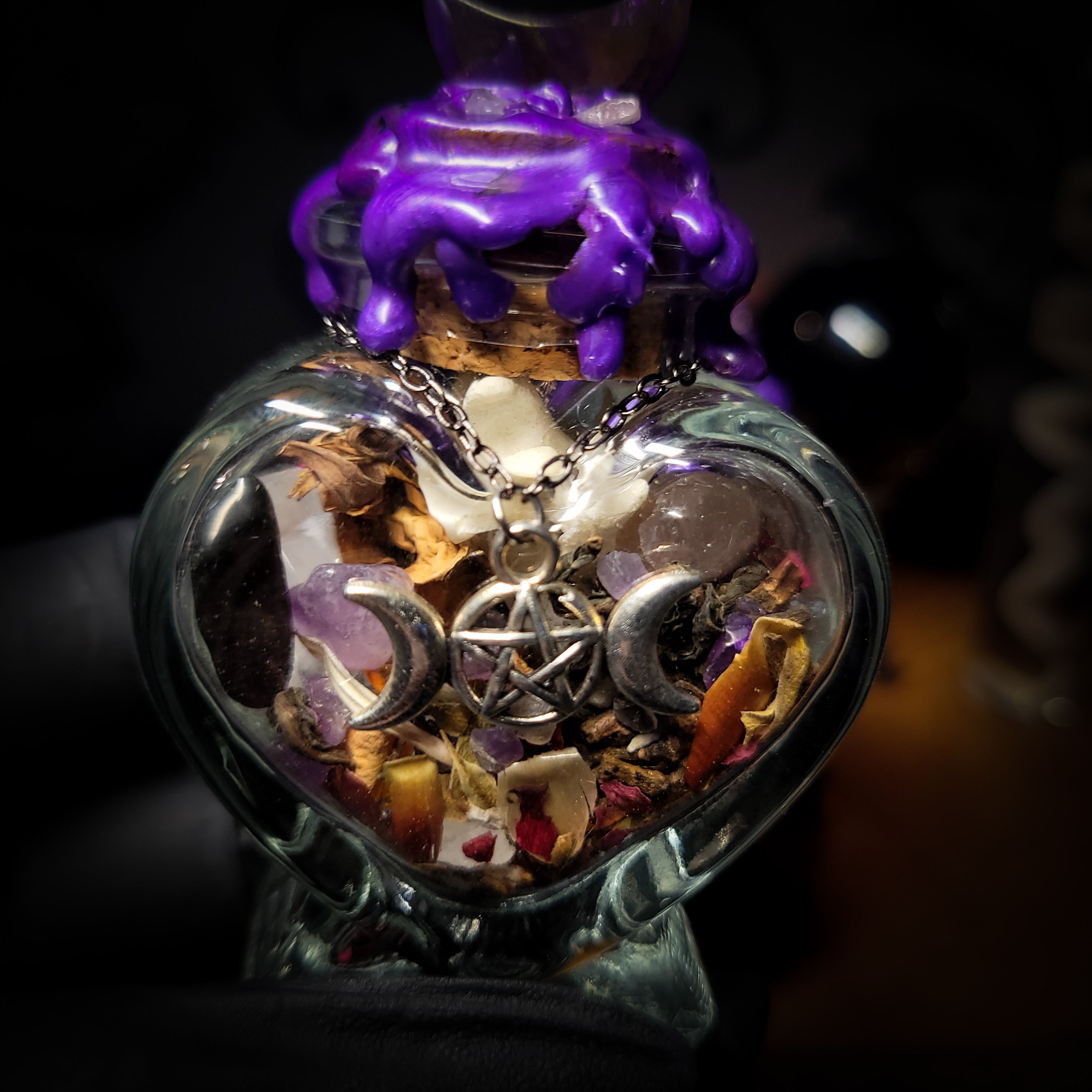 Handmade gothic twin spell jar set — two heart-shaped glass vessels sealed with violet wax and amethyst moon, filled with herbs, crystals and bones for love binding ritual