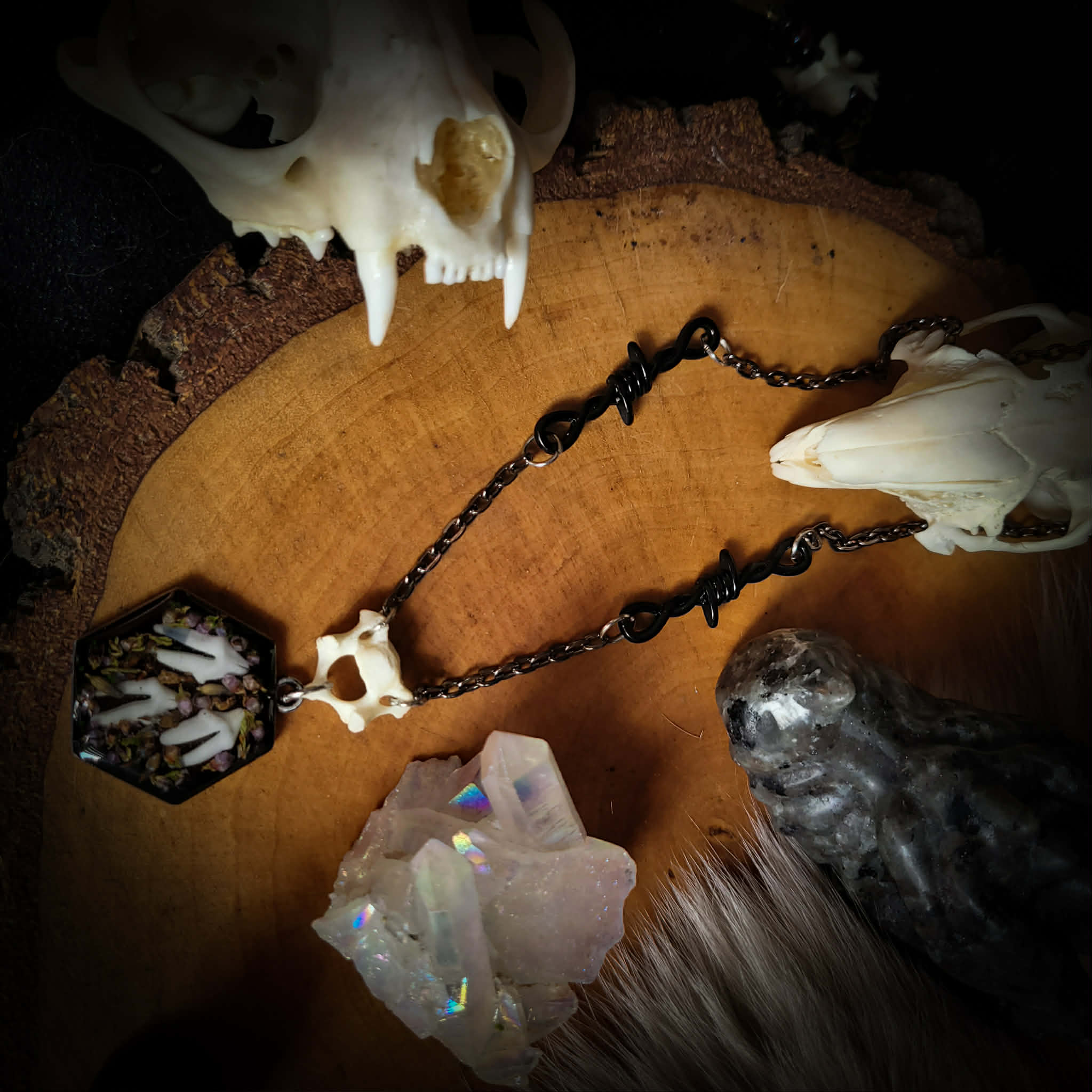 Handmade gothic necklace — real fox teeth and dried heather flowers in hexagonal resin pendant, vertebrae connector, metal bat charm