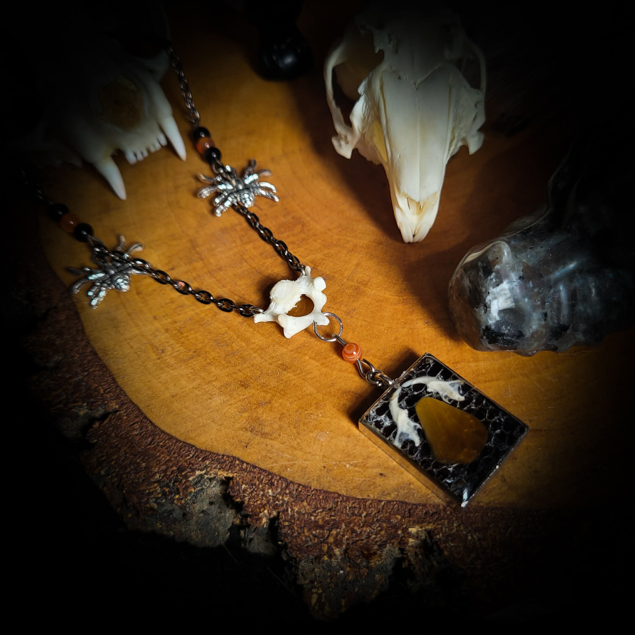 Handmade gothic necklace — tiger's eye stone and mouse jaw in resin pendant, snake skin background, vertebrae connector, metal spiders, carnelian beads
