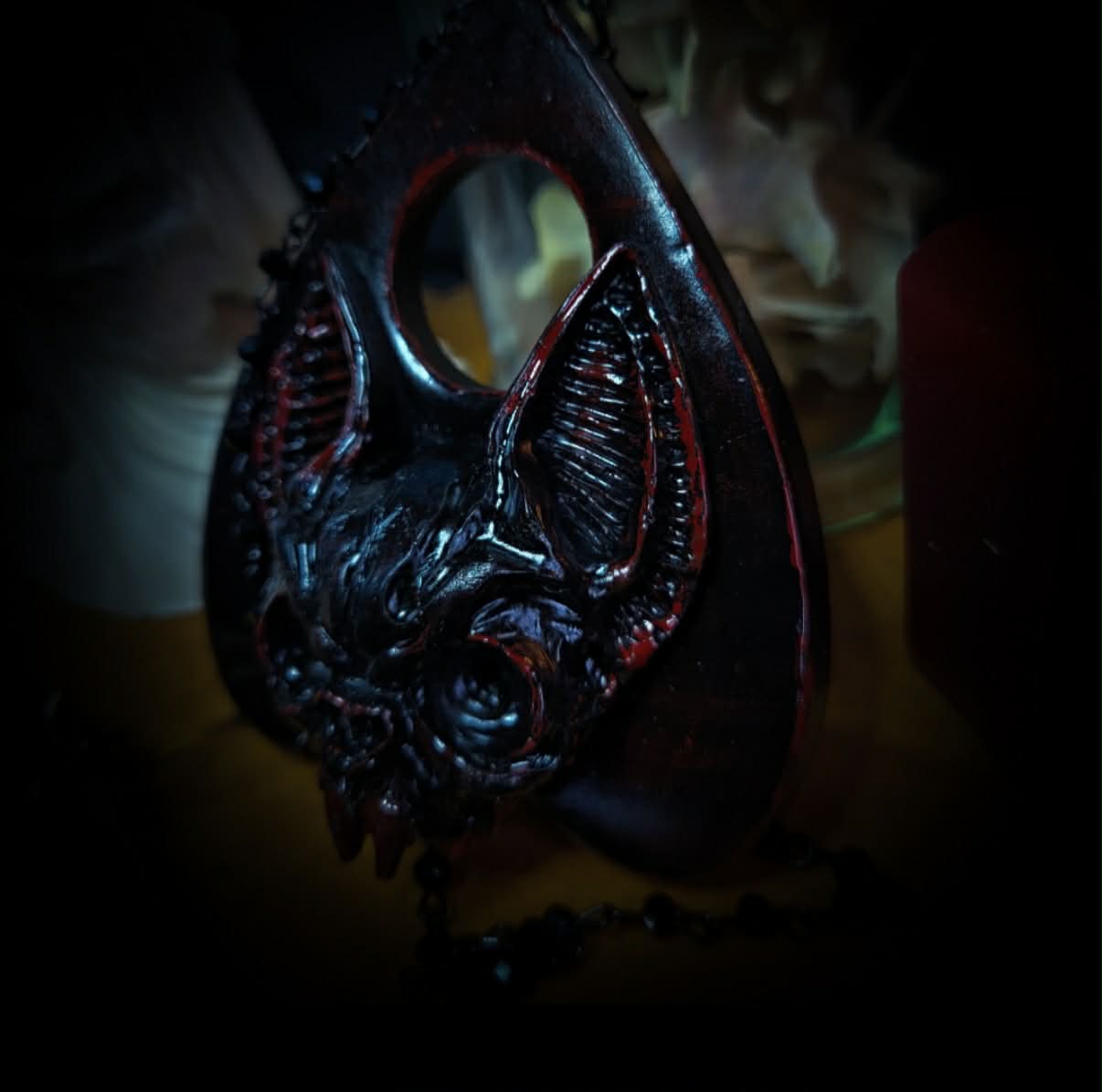 Ouija Planchette — handmade gothic planchette sculpture, made to order. Hand-cast bat and demonic face centerpiece in classic planchette shape, dark bloody finish with deep red accents. Occult altar decor, 8x9cm.