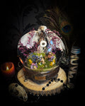 Inter Prata Fabulosa — handmade whimsical glass dome with mummified canary, crystal orb, dragon skull, wizard's hat, rolled scrolls and botanical arrangement. Morbid Oddities.