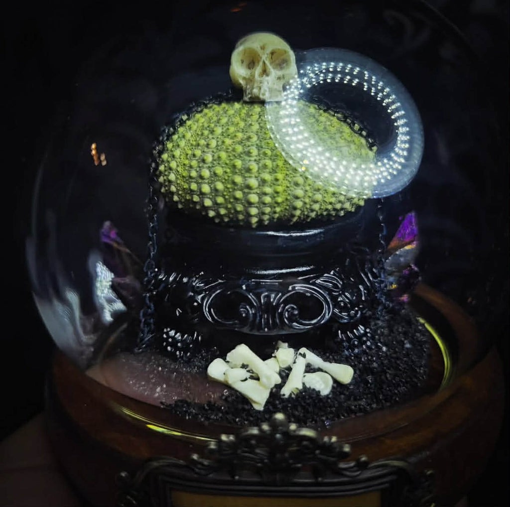 Siggurat | Occult — handmade gothic altar piece with ziggurat-inspired centerpiece, real bone elements, sea urchin skeleton, decorative crystals and chains under glass dome on hand-painted wooden base, 10x10cm