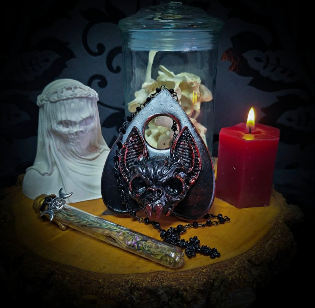 Ouija Planchette — handmade gothic planchette sculpture, made to order. Hand-cast bat and demonic face centerpiece in classic planchette shape, dark bloody finish with deep red accents. Occult altar decor, 8x9cm.