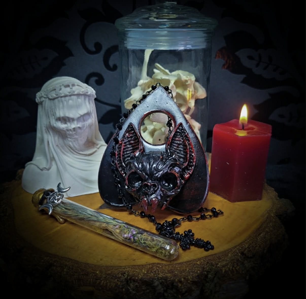 Ouija Planchette — handmade gothic planchette sculpture, made to order. Hand-cast bat and demonic face centerpiece in classic planchette shape, dark bloody finish with deep red accents. Occult altar decor, 8x9cm.