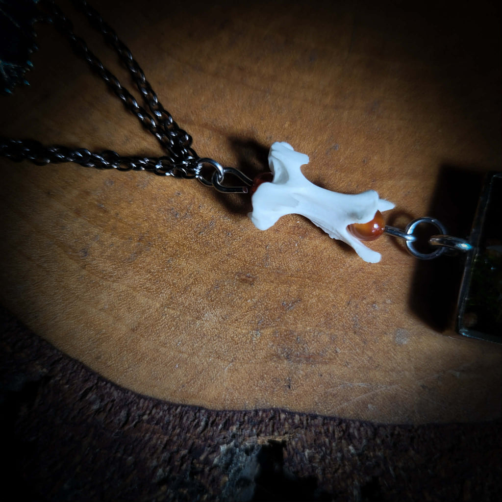 Handmade gothic necklace — mouse skull and jaw with dried flowers in hexagonal resin pendant, vertebrae connector, metal bat charm, carnelian beads
