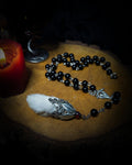 Rabbit Foot Rosary | Necklaces — handmade dark necklace with real preserved white rabbit foot, partial rosary chain, carnelian beads and ornamental metal detail, macabre alternative jewellery