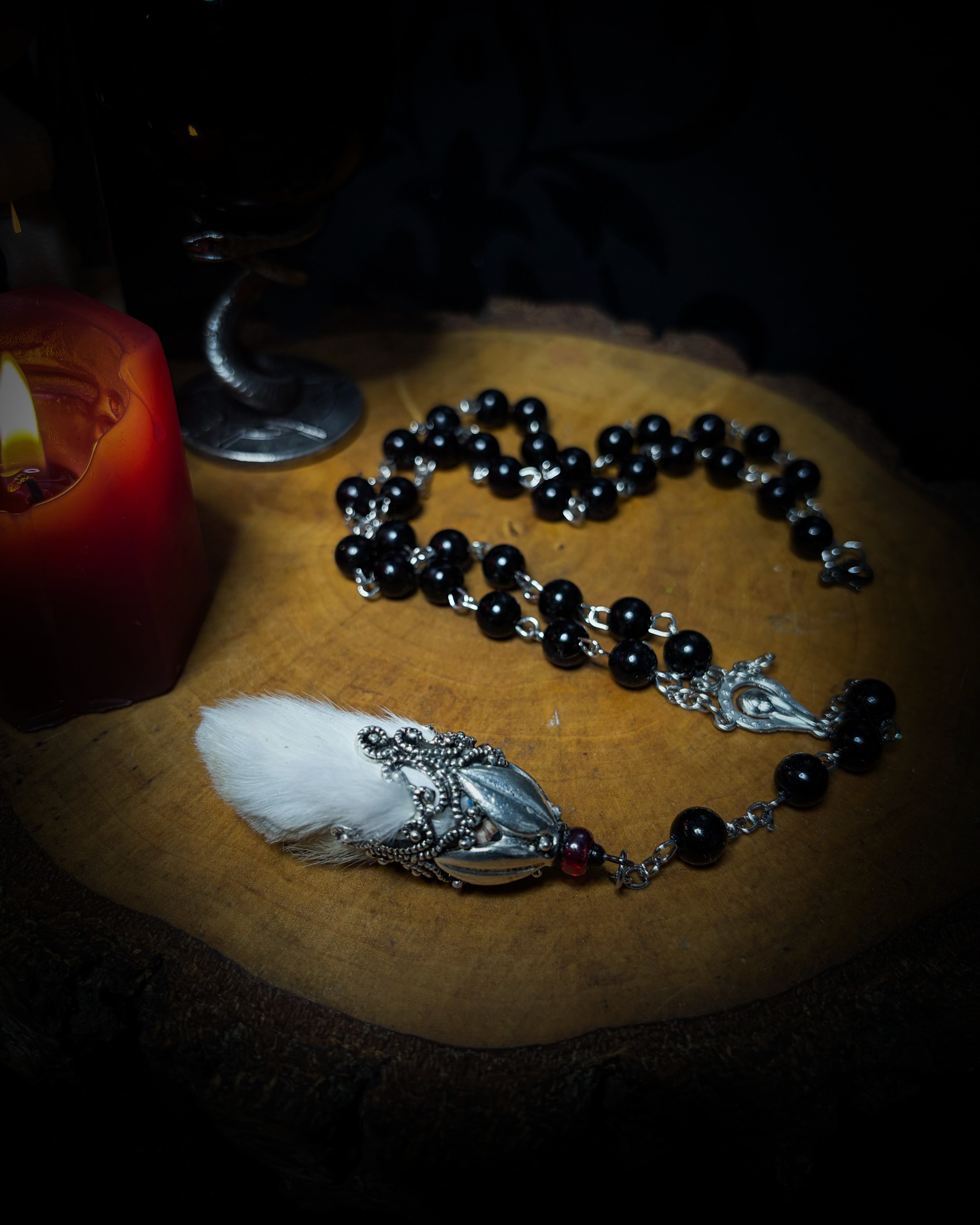 Rabbit Foot Rosary | Necklaces — handmade dark necklace with real preserved white rabbit foot, partial rosary chain, carnelian beads and ornamental metal detail, macabre alternative jewellery