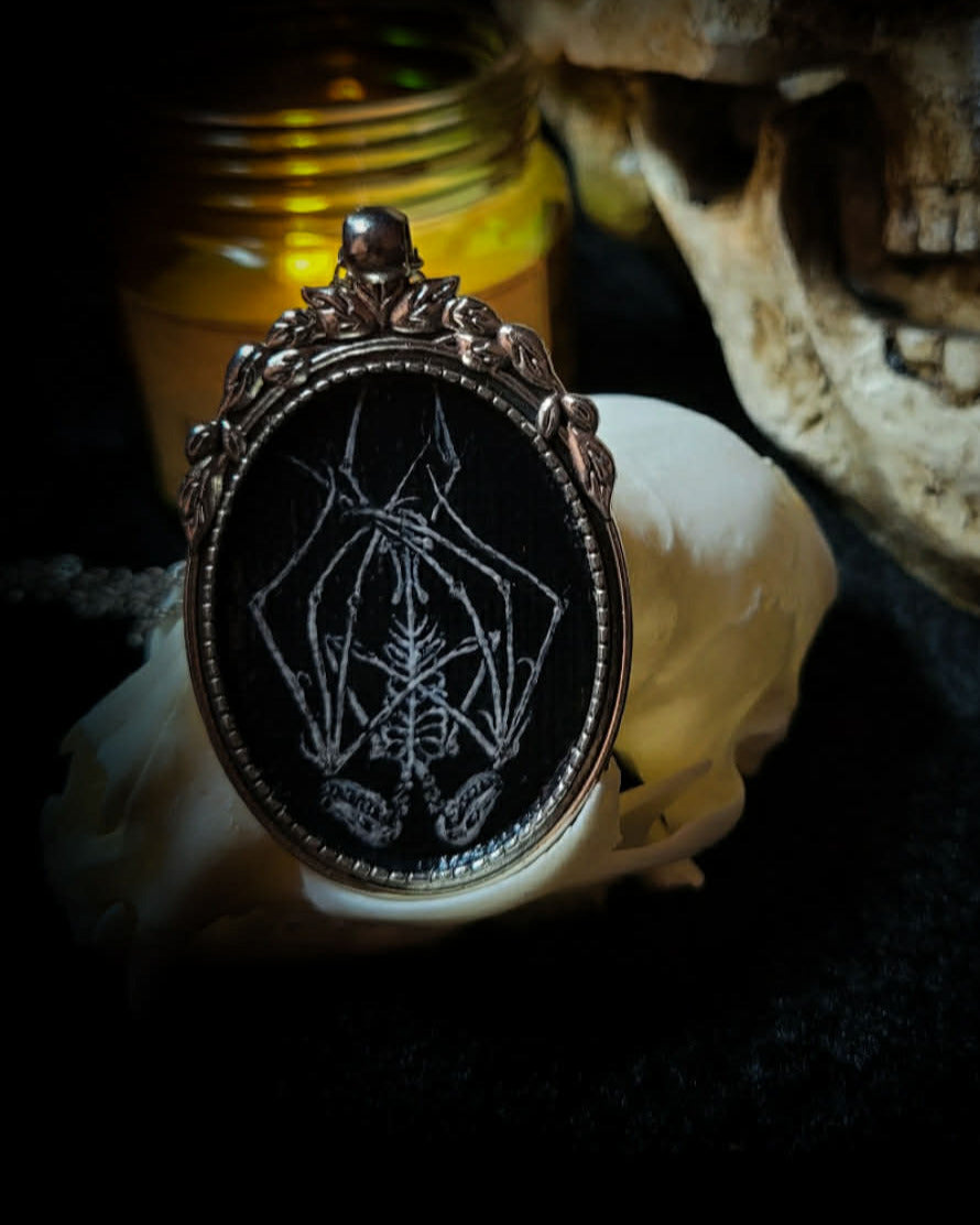 Handmade gothic necklace — hand-painted bat sigil, oval pendant with metal frame and chain, varnish finish