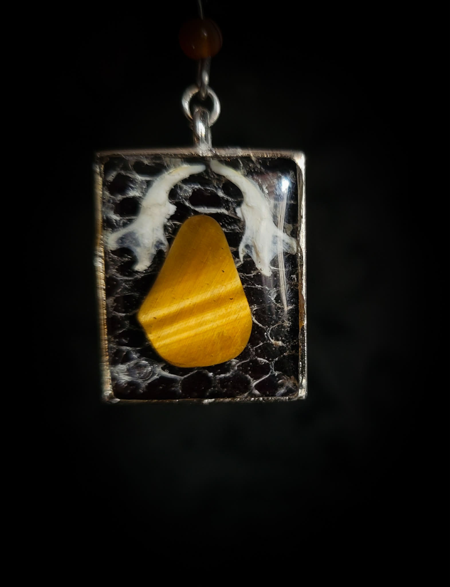 Handmade gothic necklace — tiger's eye stone and mouse jaw in resin pendant, snake skin background, vertebrae connector, metal spiders, carnelian beads