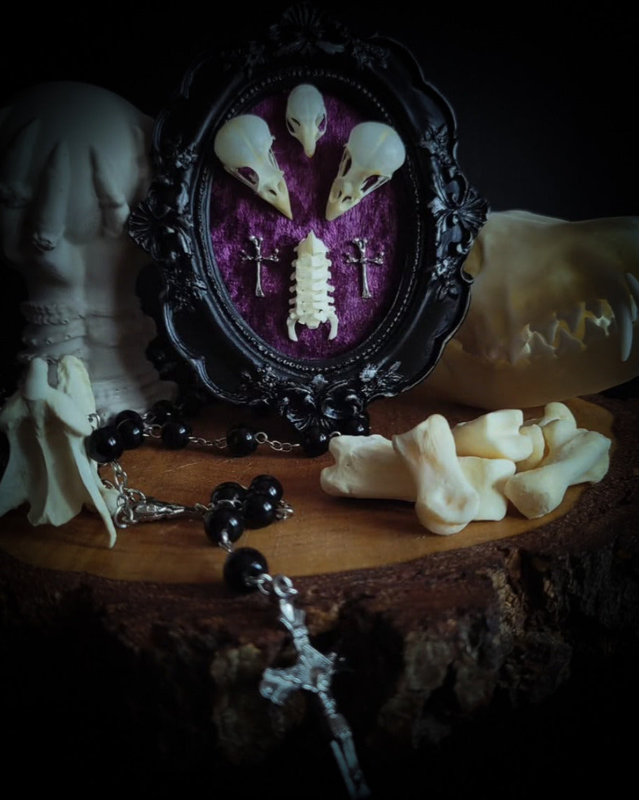 Velora | Small Relics — handmade gothic wall decor with two real bird skulls, mouse skull and rat spine section in hand-painted frame on deep purple velvet, dark macabre aesthetic, 12x10cm