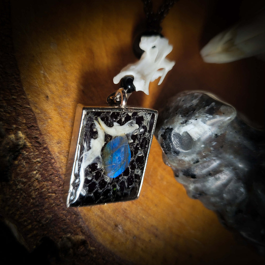 Handmade gothic necklace — labradorite stone and mouse jaw in resin pendant, snake skin background, vertebrae connector, metal bat charm
