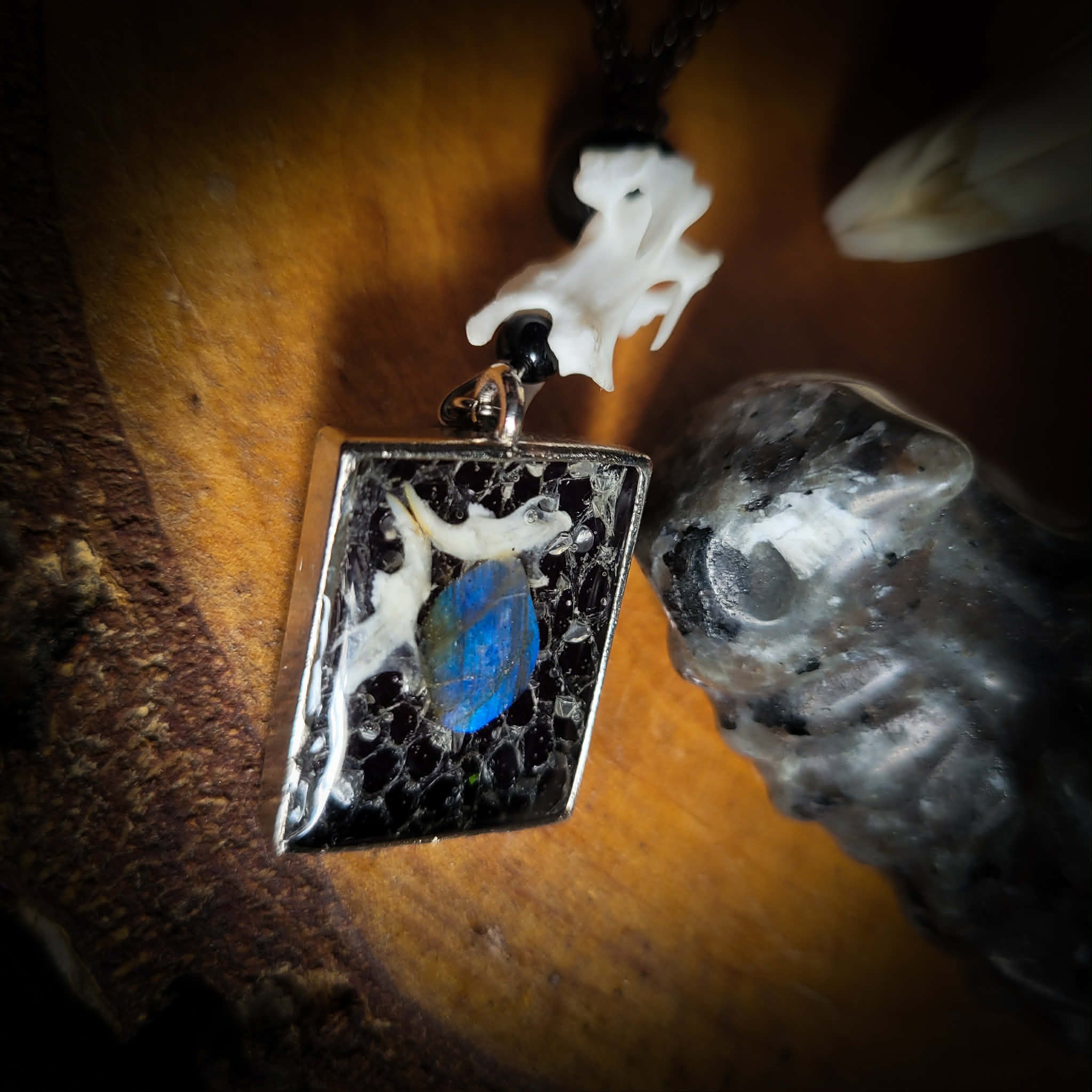 Handmade gothic necklace — labradorite stone and mouse jaw in resin pendant, snake skin background, vertebrae connector, metal bat charm