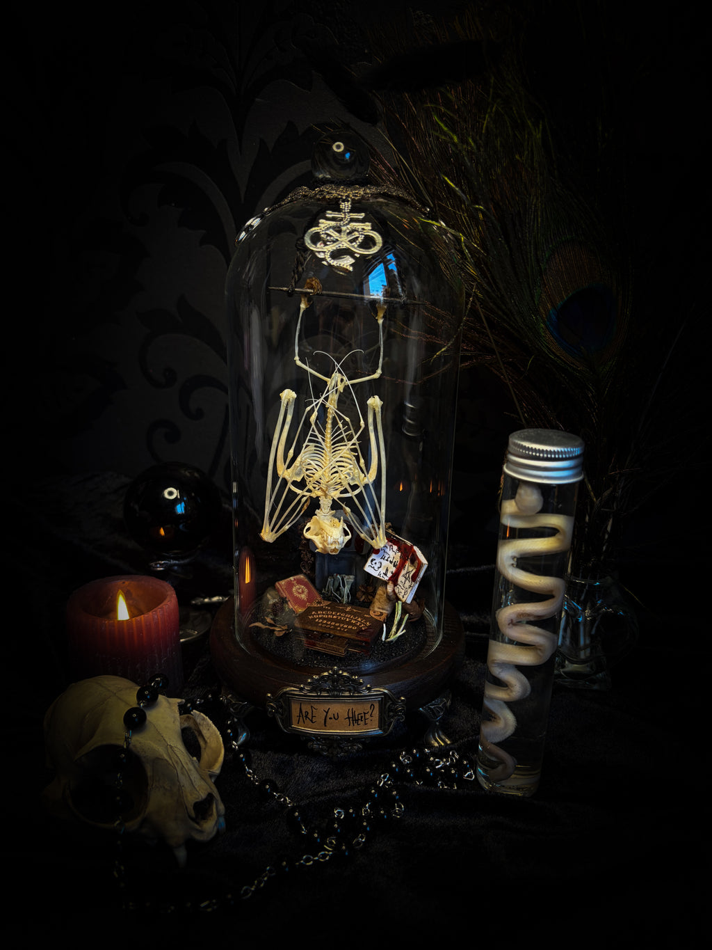 Handmade gothic occult display — bat skeleton in glass dome with Leviathan sigil, cemetery vignette with ouija board and necromancer book, 12x24cm