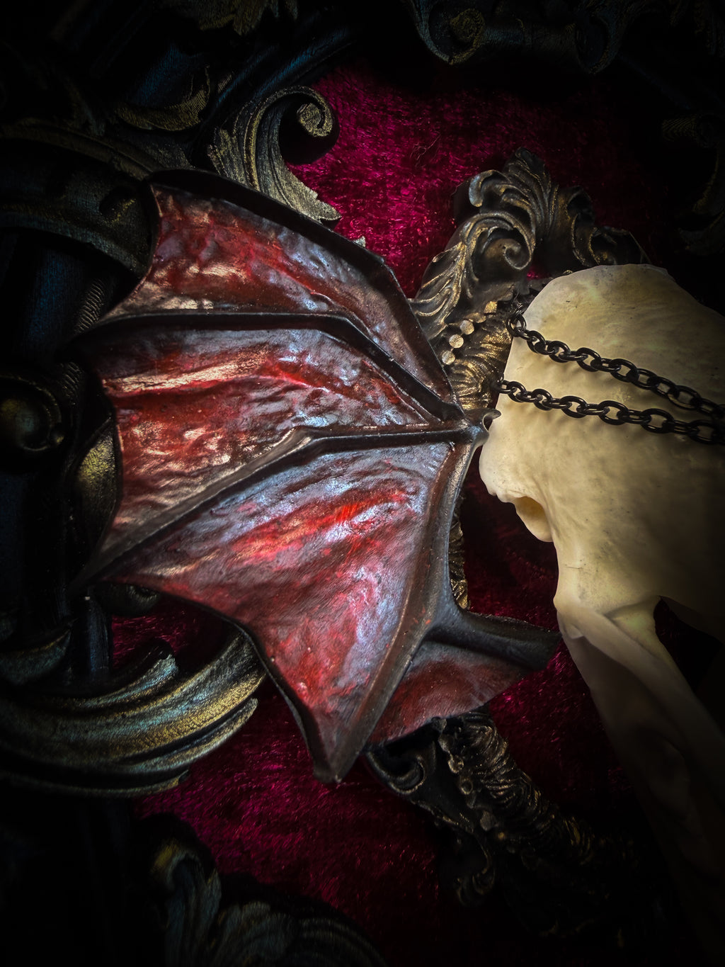 Handmade gothic wall decor with real mink skull, hand-cast bat wings, red velvet and gold frame — Malachar by Morbid Oddities