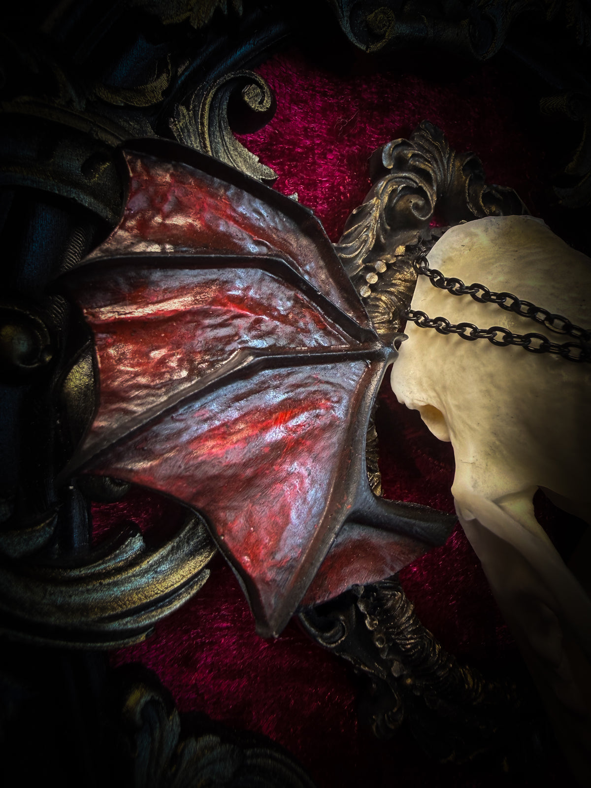 Handmade gothic wall decor with real mink skull, hand-cast bat wings, red velvet and gold frame — Malachar by Morbid Oddities