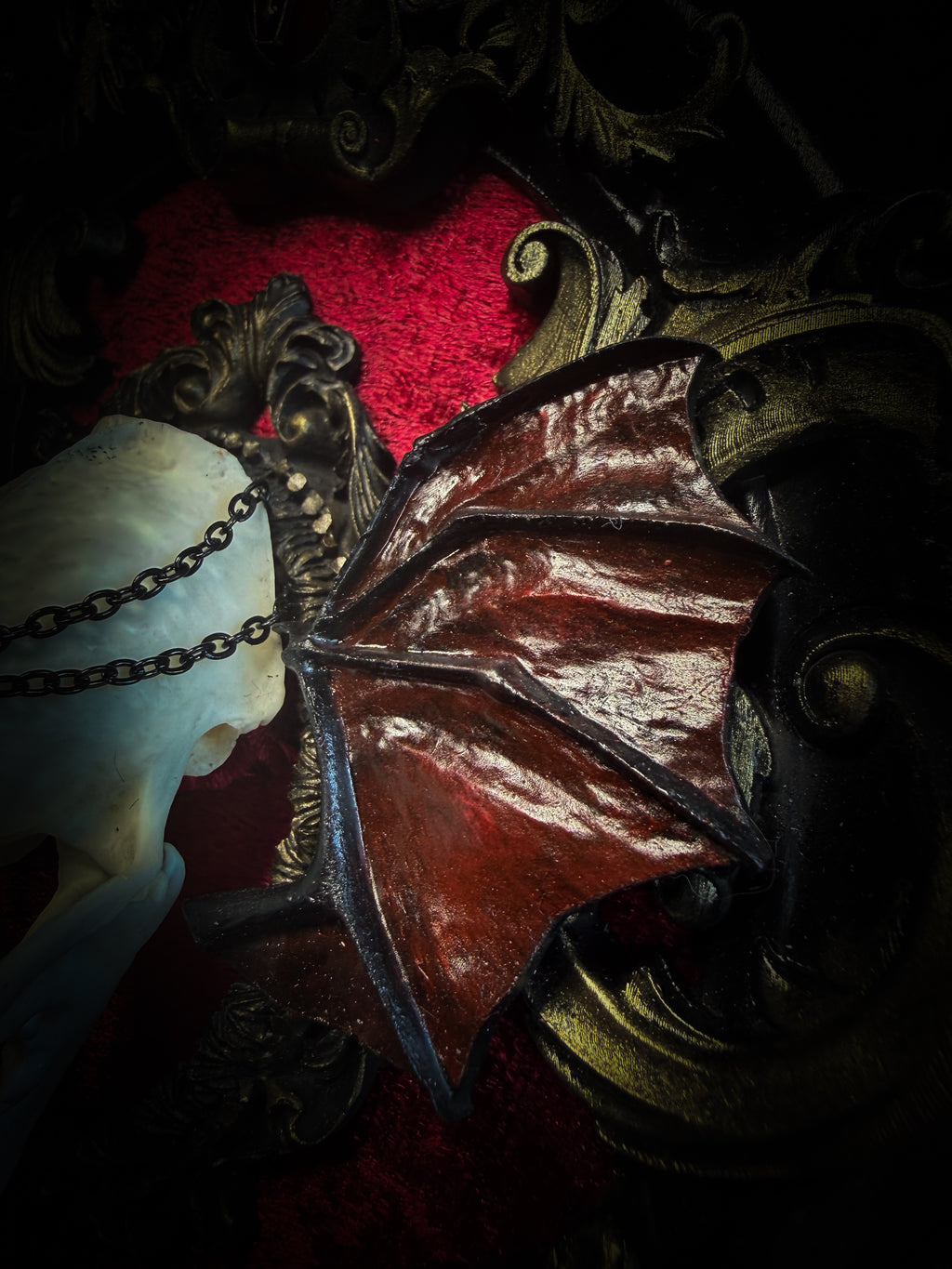 Handmade gothic wall decor with real mink skull, hand-cast bat wings, red velvet and gold frame — Malachar by Morbid Oddities