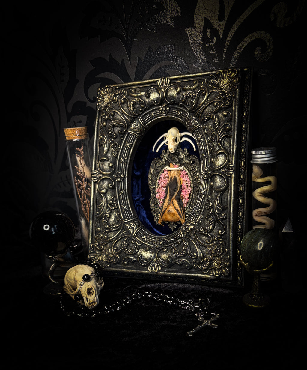 Floral Delight | Bats — handmade gothic wall decor with real preserved bat, bat skull, bone ribs, deep pink preserved flowers on navy velvet in aged hand-cast ornamental frame with glass, 25x19cm