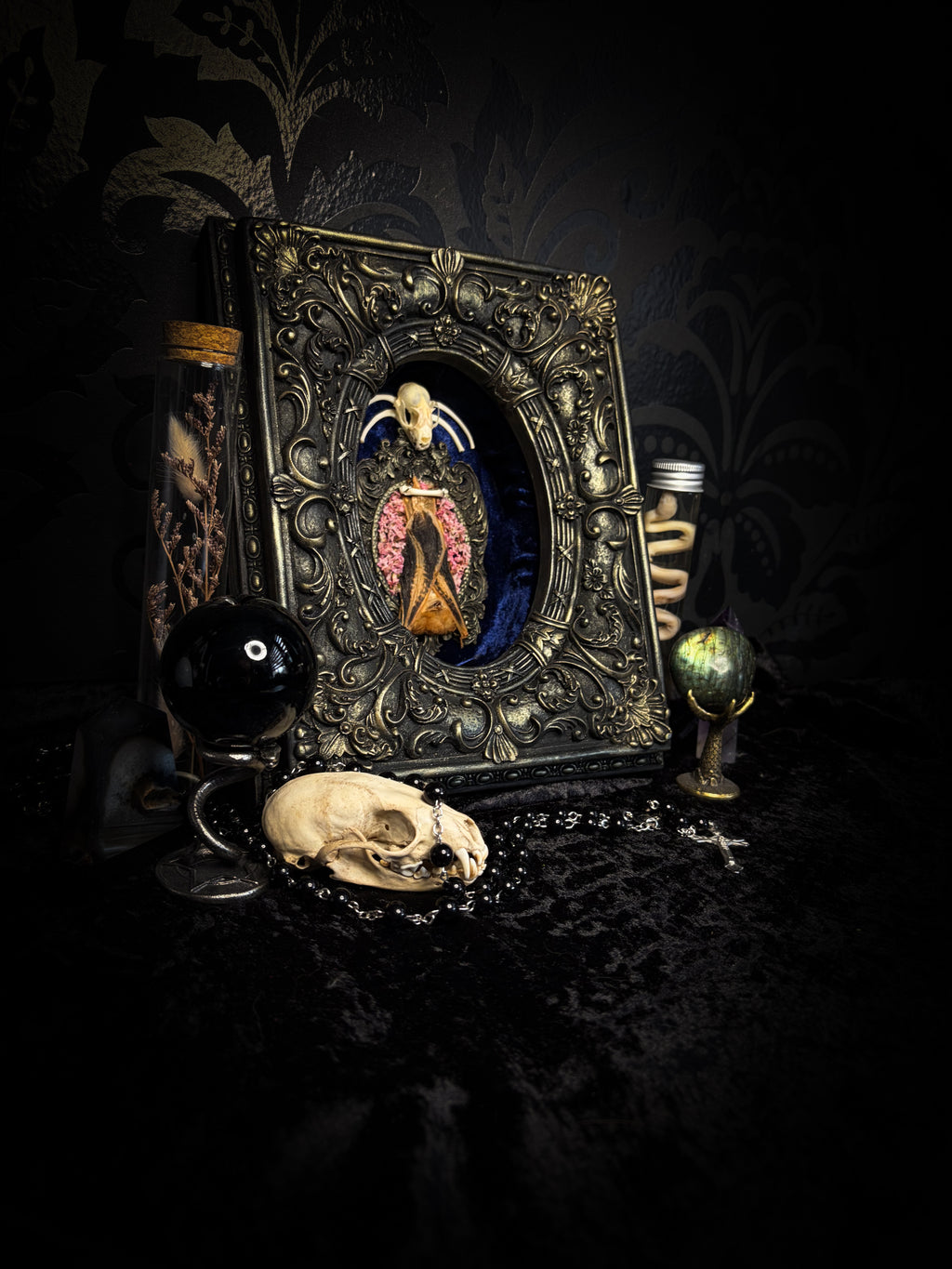 Floral Delight | Bats — handmade gothic wall decor with real preserved bat, bat skull, bone ribs, deep pink preserved flowers on navy velvet in aged hand-cast ornamental frame with glass, 25x19cm