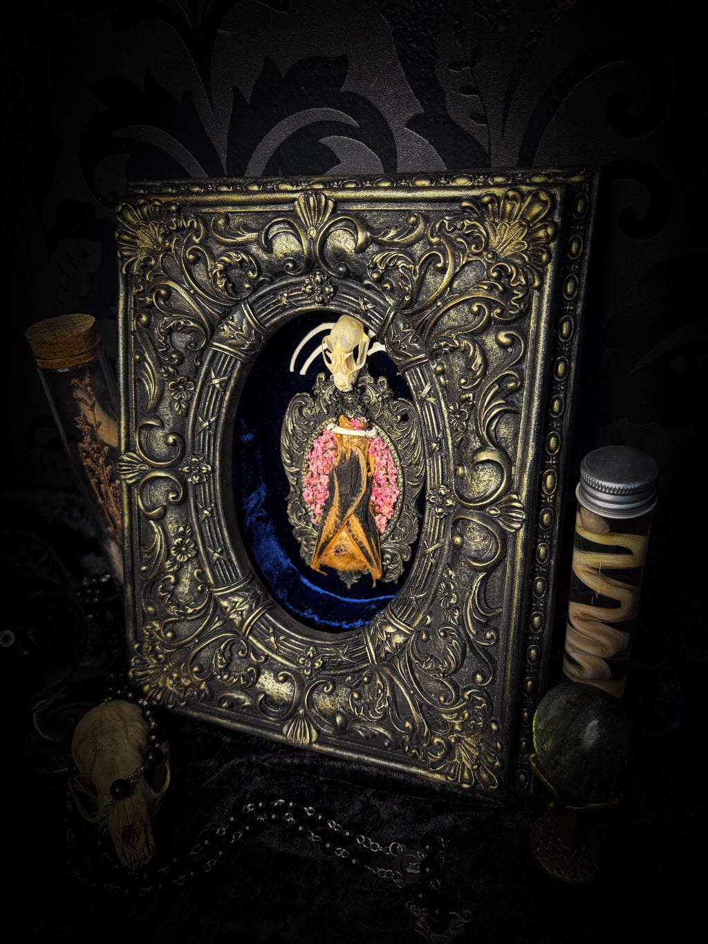 Floral Delight | Bats — handmade gothic wall decor with real preserved bat, bat skull, bone ribs, deep pink preserved flowers on navy velvet in aged hand-cast ornamental frame with glass, 25x19cm