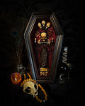 Sanguis Aeternus: mummified bat in a handmade wooden coffin with burgundy velvet, a hooded winged vampire skull, raven skull ornaments and decorative blood vials.


