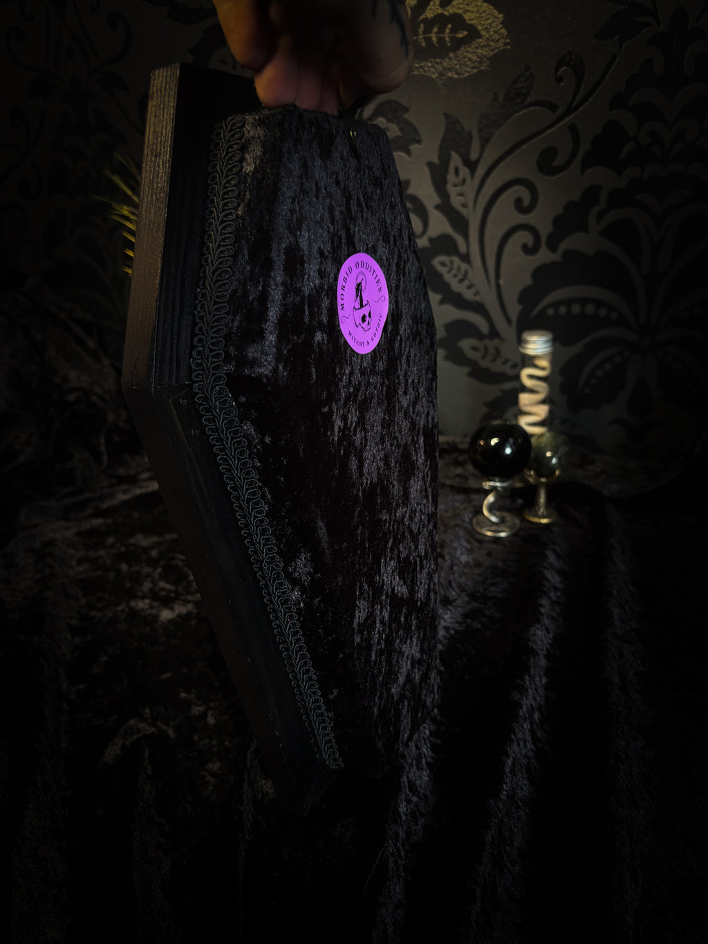 Sanguis Aeternus: mummified bat in a handmade wooden coffin with burgundy velvet, a hooded winged vampire skull, raven skull ornaments and decorative blood vials.

