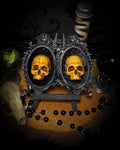 Ever After by Morbid Oddities, two patinated adult skull casts on black velvet in an ornate black double frame with silver detailing.