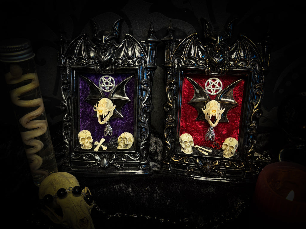Violet Hex — handmade gothic wall relic, ready to ship. Real bat skull with hand-cast wings on violet crushed velvet in black and gold frame with sculpted bat, ornamental skulls, wax rose and pentagram details. One-of-a-kind dark decor, 16x11cm.