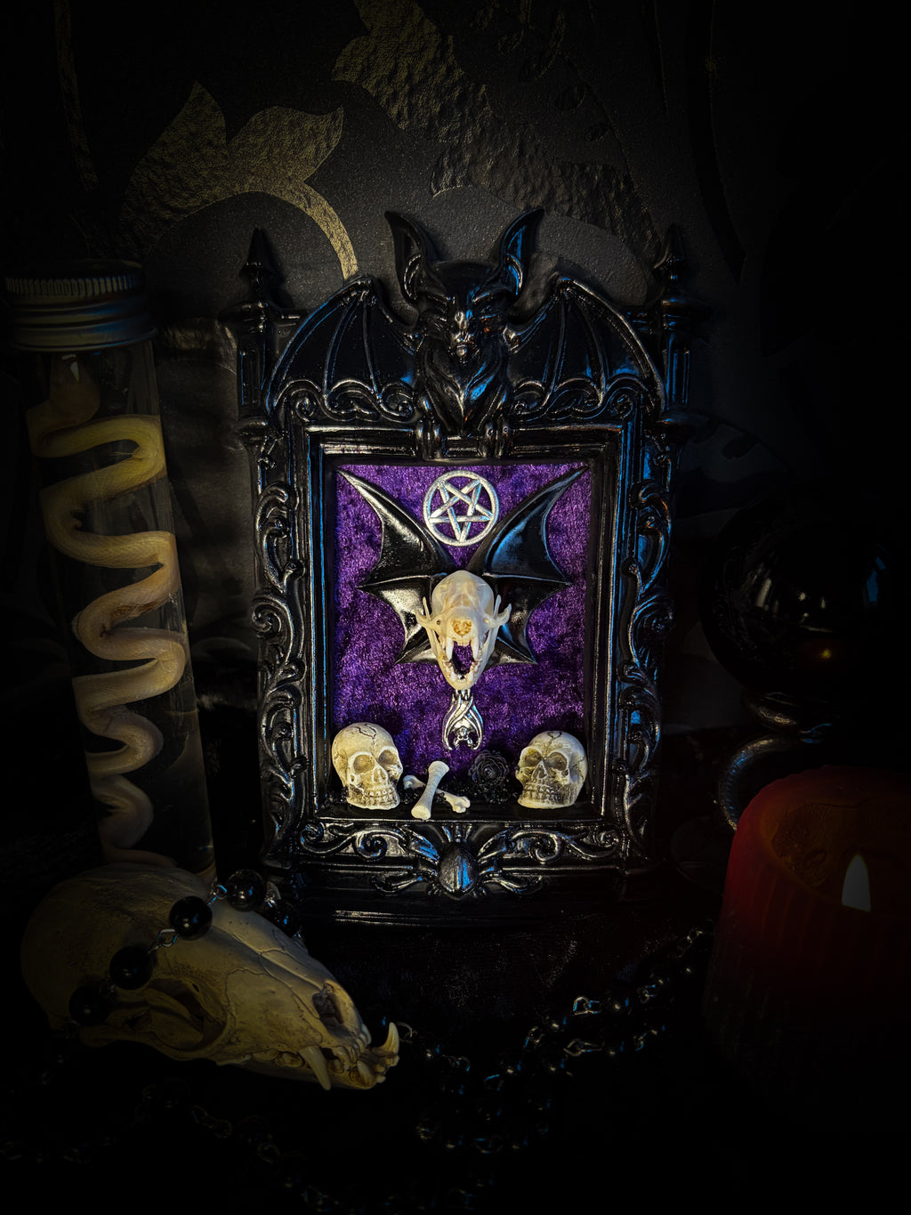 Violet Hex — handmade gothic wall relic, ready to ship. Real bat skull with hand-cast wings on violet crushed velvet in black and gold frame with sculpted bat, ornamental skulls, wax rose and pentagram details. One-of-a-kind dark decor, 16x11cm.
