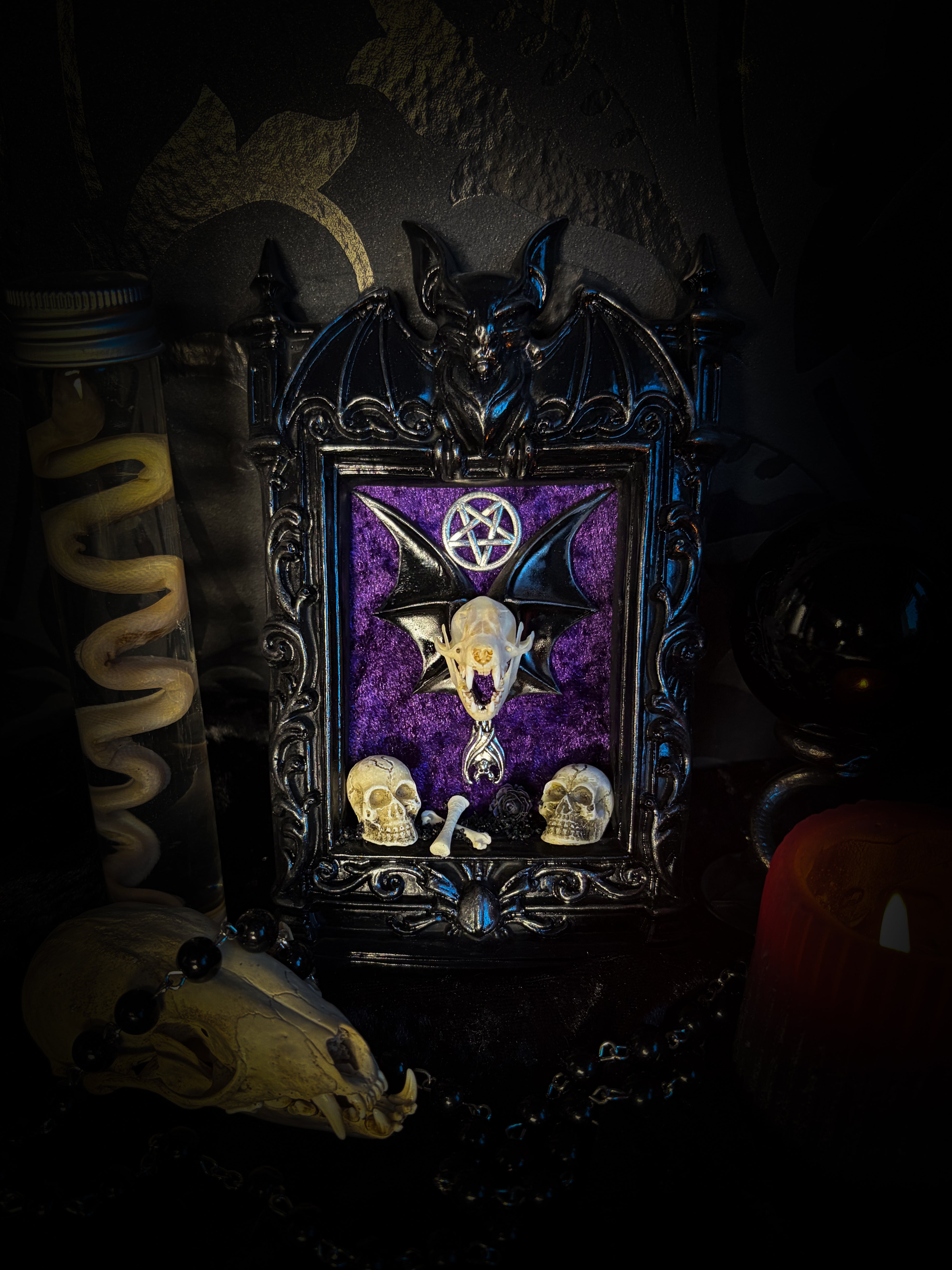 Violet Hex — handmade gothic wall relic, ready to ship. Real bat skull with hand-cast wings on violet crushed velvet in black and gold frame with sculpted bat, ornamental skulls, wax rose and pentagram details. One-of-a-kind dark decor, 16x11cm.