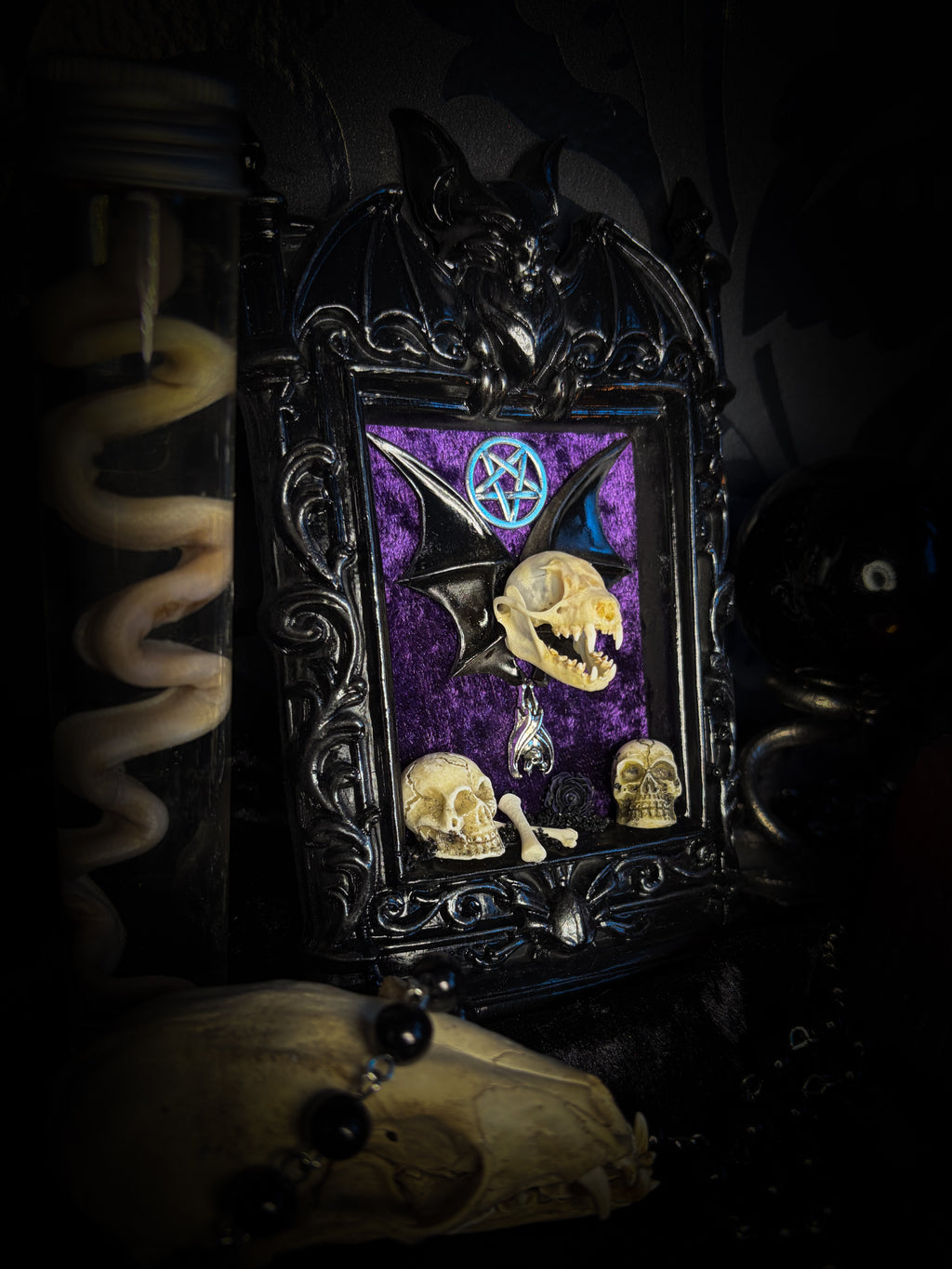 Violet Hex — handmade gothic wall relic, ready to ship. Real bat skull with hand-cast wings on violet crushed velvet in black and gold frame with sculpted bat, ornamental skulls, wax rose and pentagram details. One-of-a-kind dark decor, 16x11cm.