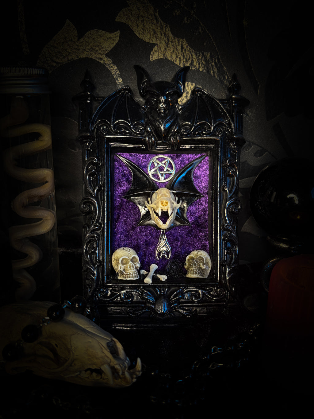 Violet Hex — handmade gothic wall relic, ready to ship. Real bat skull with hand-cast wings on violet crushed velvet in black and gold frame with sculpted bat, ornamental skulls, wax rose and pentagram details. One-of-a-kind dark decor, 16x11cm.