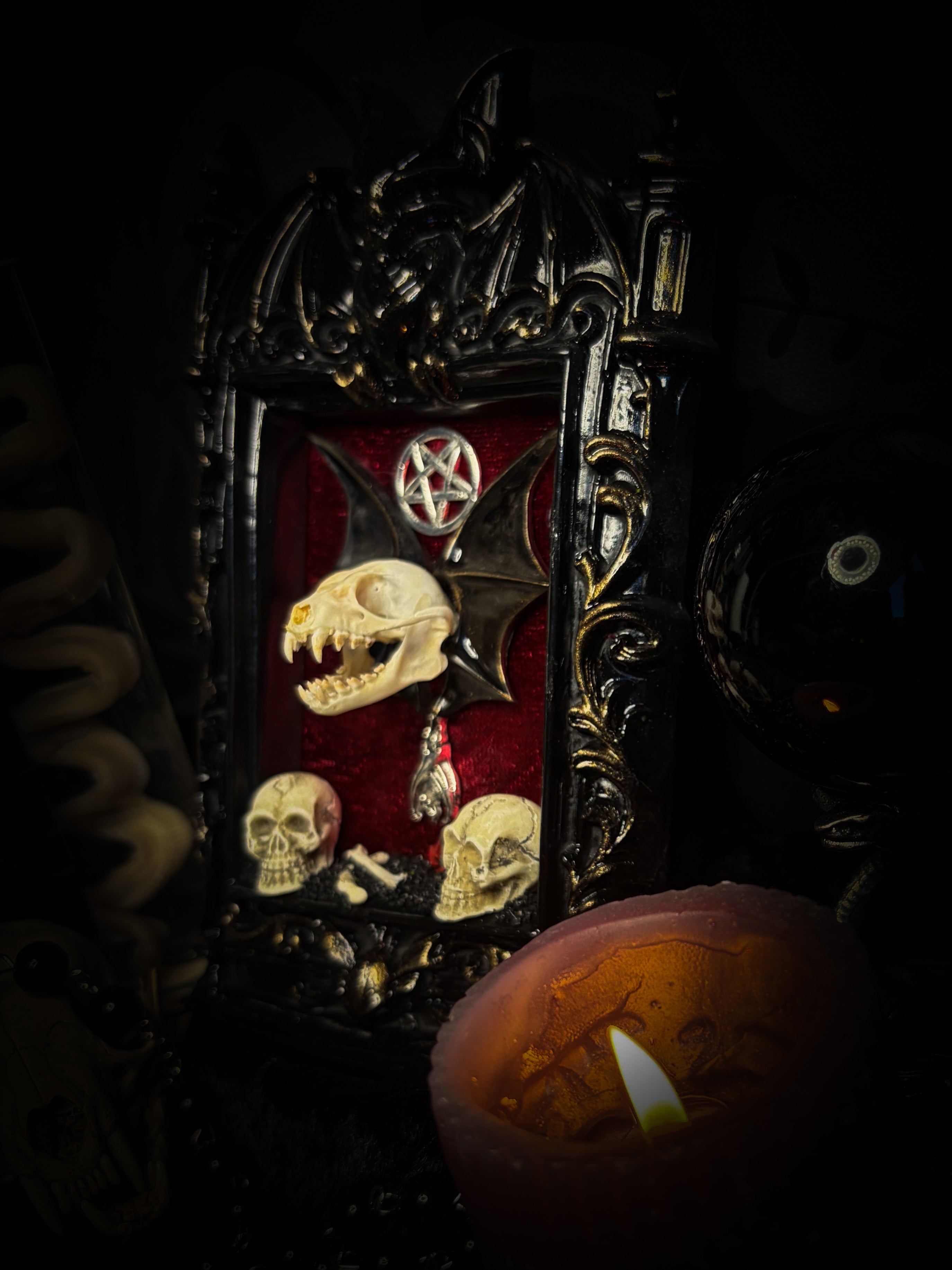 Crimson Ritual — handmade gothic wall relic, ready to ship. Real bat skull with hand-cast wings on crimson crushed velvet in black and gold frame with sculpted bat, ornamental skulls, wax rose and pentagram details. One-of-a-kind dark decor, 16x11cm.
