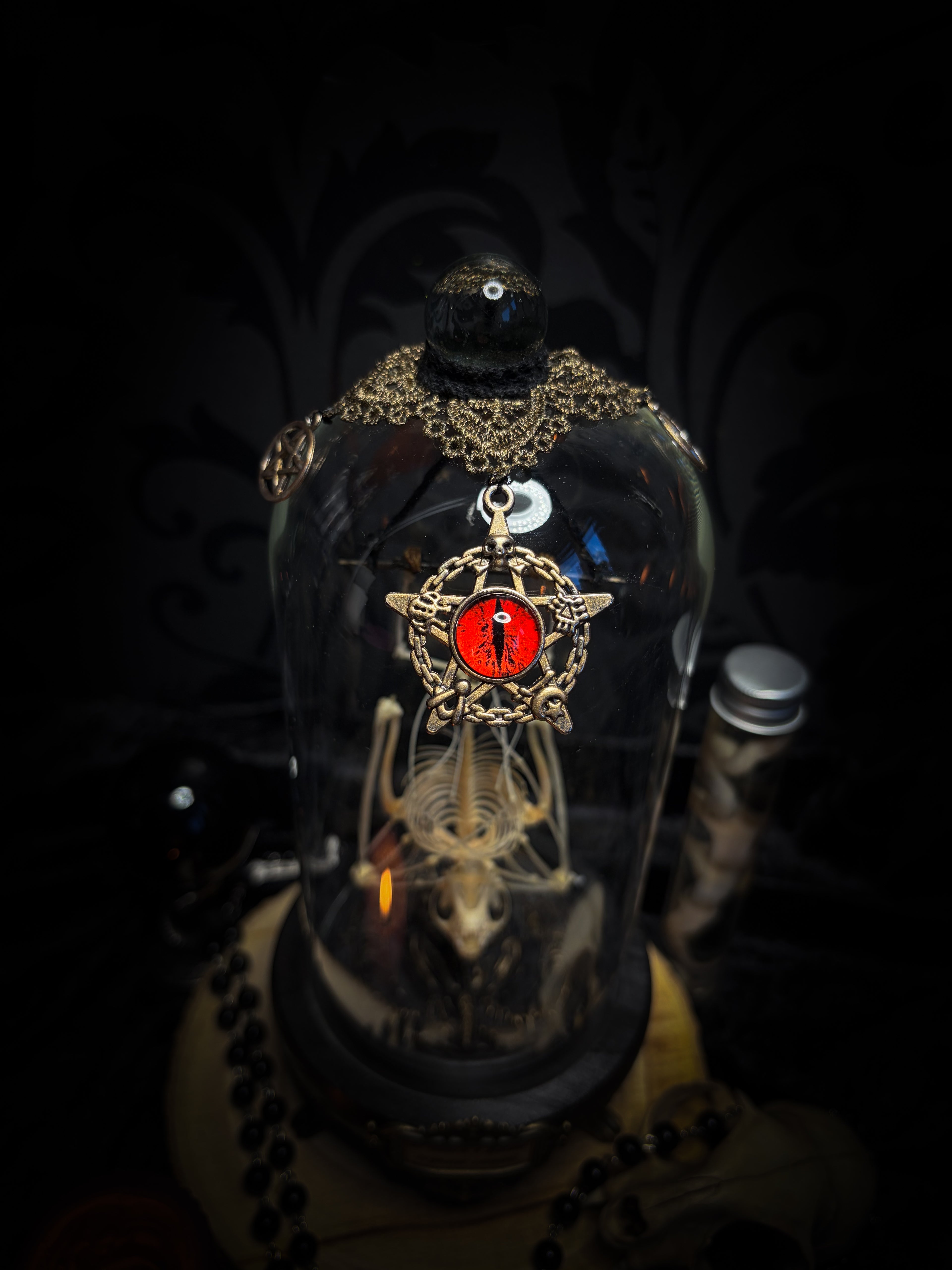 Fangtasia — handmade gothic glass dome display, ready to ship. Suspended bat skeleton under glass cloche with ornate sigil pendant, red glass eye and Latin inscription plaque, aged finish. One-of-a-kind occult decor, 12x24cm.