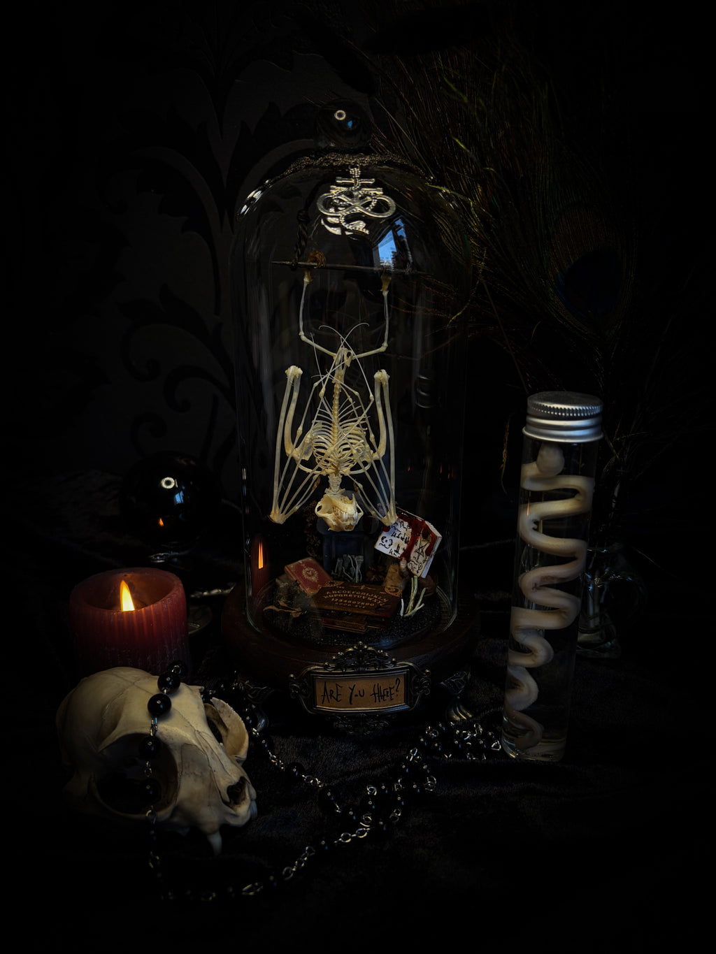 Handmade gothic occult display — bat skeleton in glass dome with Leviathan sigil, cemetery vignette with ouija board and necromancer book, 12x24cm