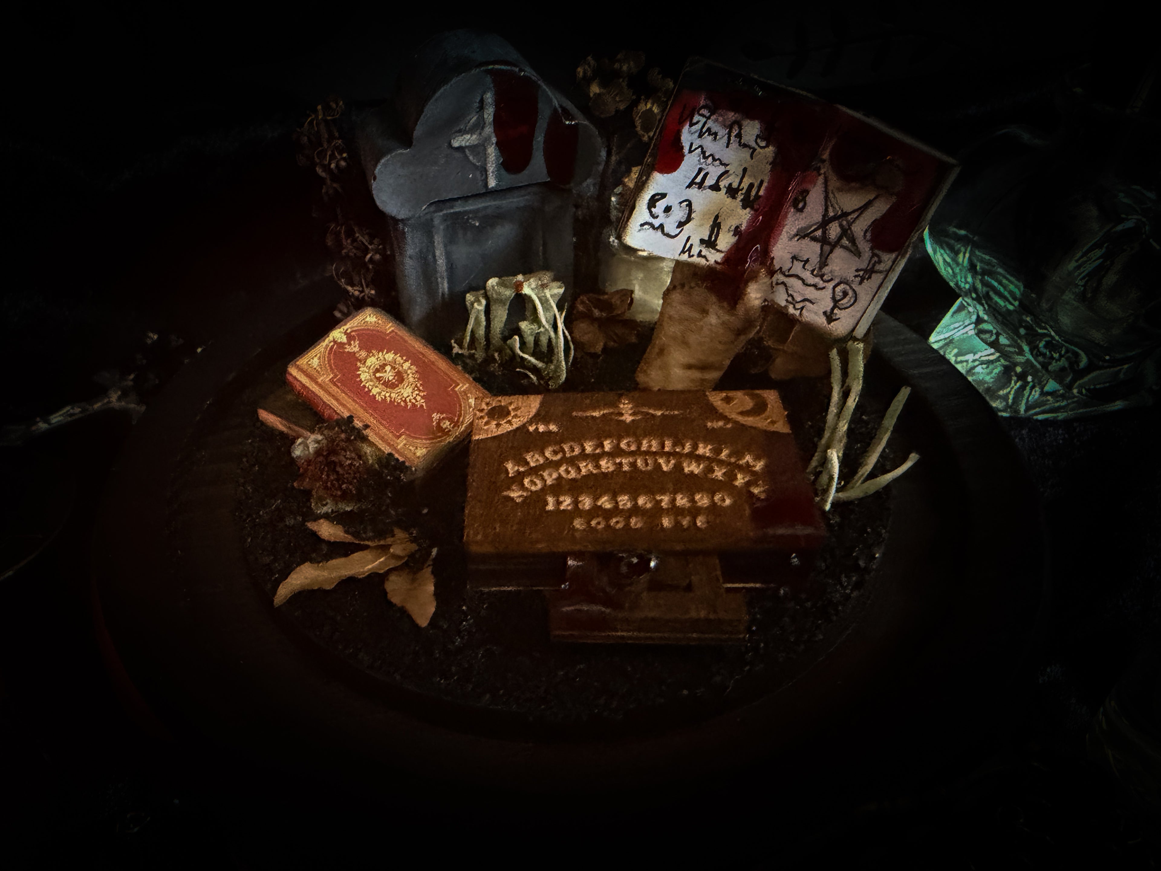 Handmade gothic occult display — bat skeleton in glass dome with Leviathan sigil, cemetery vignette with ouija board and necromancer book, 12x24cm