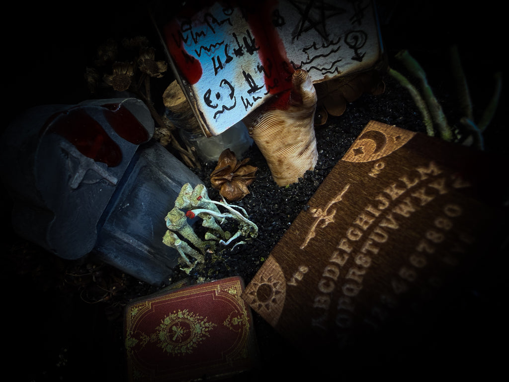 Handmade gothic occult display — bat skeleton in glass dome with Leviathan sigil, cemetery vignette with ouija board and necromancer book, 12x24cm