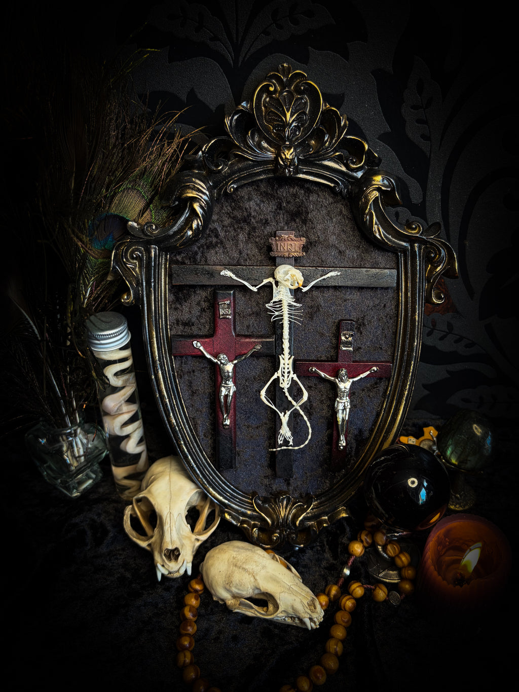 Golgotha | handmade occult relic with real mouse skeleton on three crosses with INRI inscription, cast and painted black and gold frame, black velvet backing | Morbid Oddities
